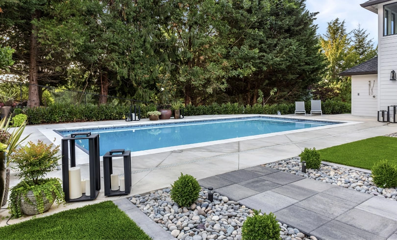 Backyard outdoor swimming pool behind new luxury home